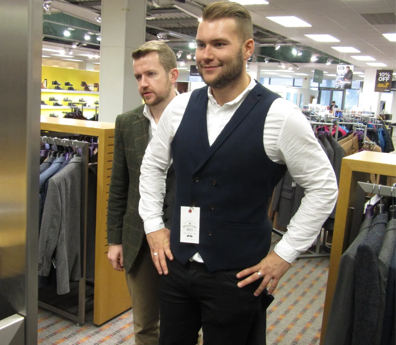 Rupert styling a gentleman client in a department store.