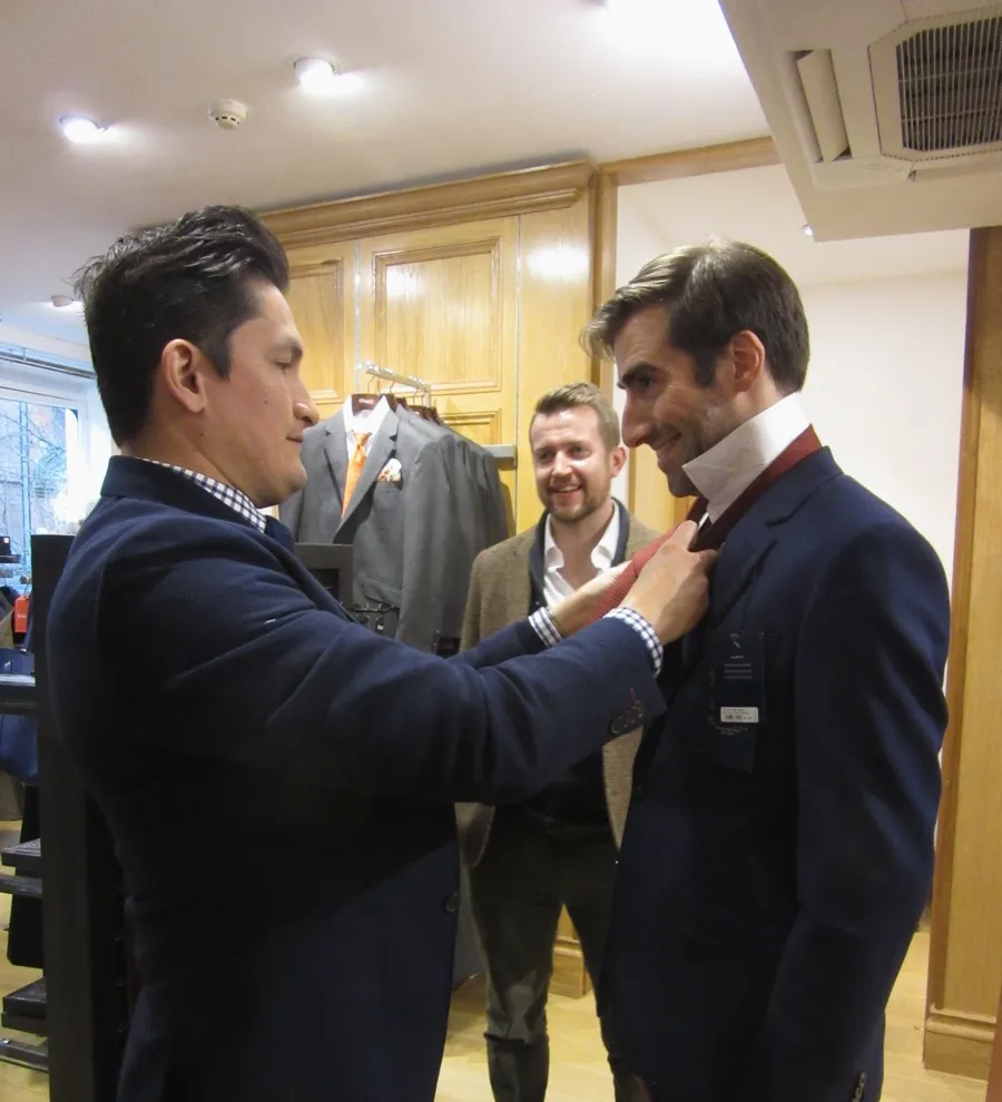 Rupert styling his client with a tailor